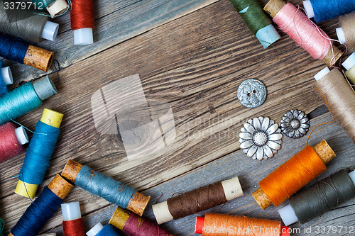 Image of old reels of varicolored thread and vintage buttons