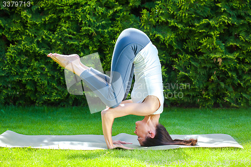 Image of pretty adult woman doing yoga