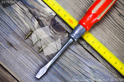 Image of Vintage screwdriver, screws and measuring lenght