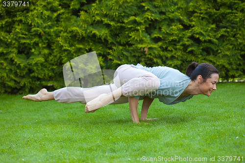 Image of pretty adult woman doing yoga