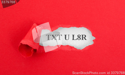 Image of Text appearing behind torn red envelop