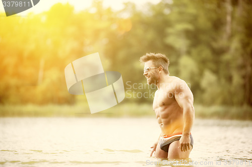 Image of muscular man lake