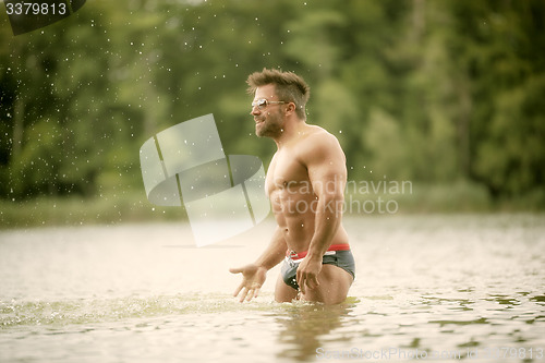 Image of muscular man lake