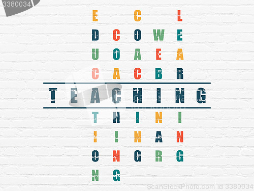Image of Education concept: word Teaching in solving Crossword Puzzle