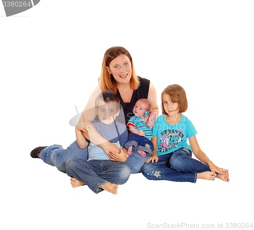 Image of Mother with her three kids sitting on floor.