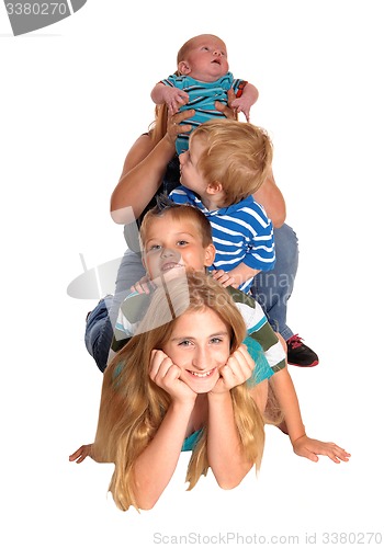 Image of Pyramid of four kids on floor.