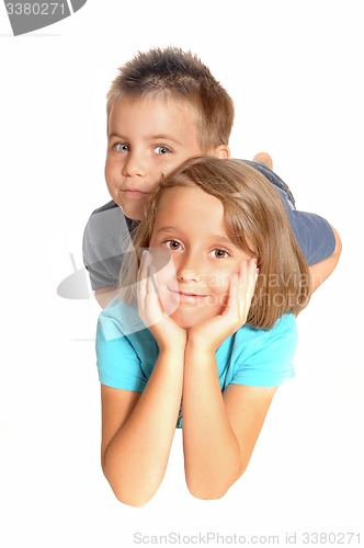 Image of A sister and brother lying on the floor.
