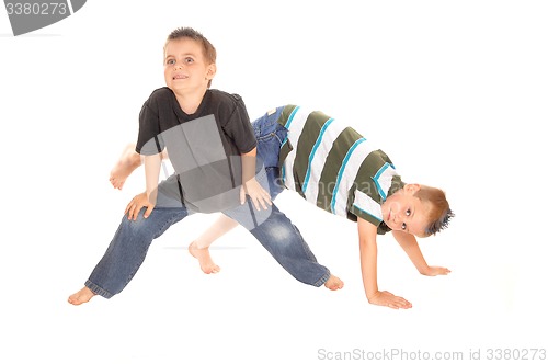 Image of Two little boy\'s dancing on the floor.