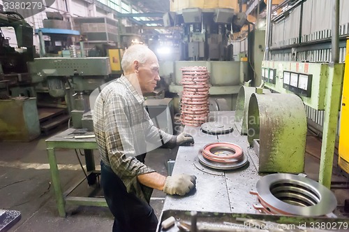 Image of Senior worker checks balancing of detail