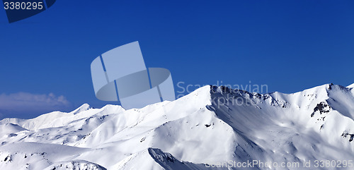 Image of Panoramic view on off-piste snowy slope at sunny day