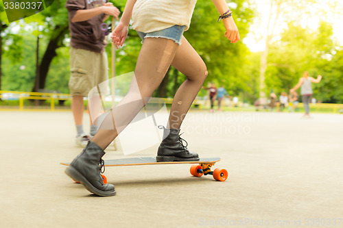 Image of Teenage girl urban long board riding.