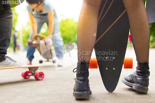 Image of Teenage girl urban long board riding.