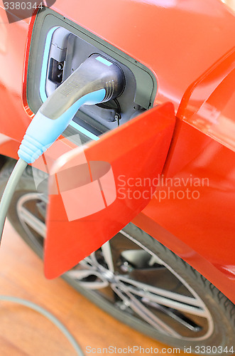 Image of Modern car with eco friendly electric engine at charging station