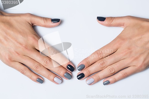 Image of Hand with a stylish gray manicure isolated on white background