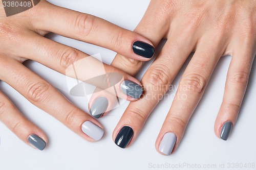 Image of Hand with a stylish gray manicure isolated on white background