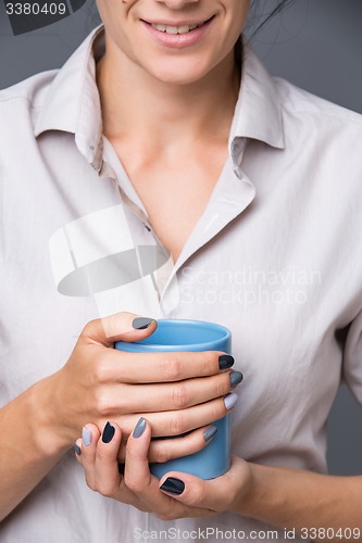 Image of Female hands with blue cup