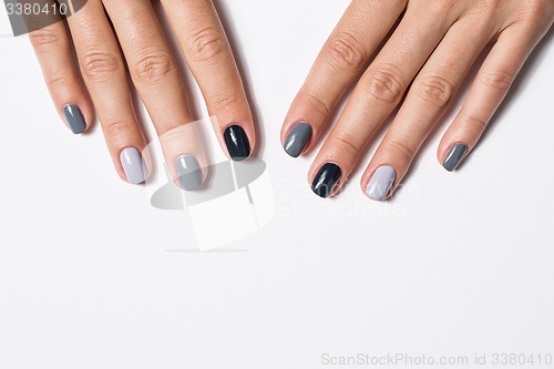 Image of Hand with a stylish gray manicure isolated on white background