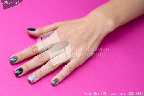 Image of Delicate female hand with a stylish neutral manicure
