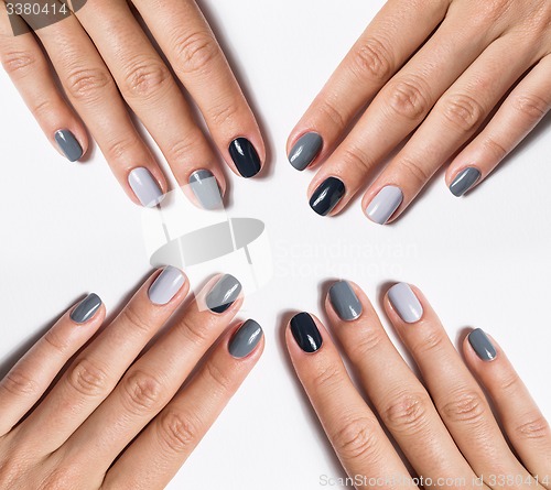 Image of Hand with a stylish gray manicure isolated on white background