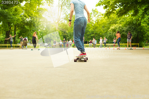 Image of Girl practicing urban long board riding.