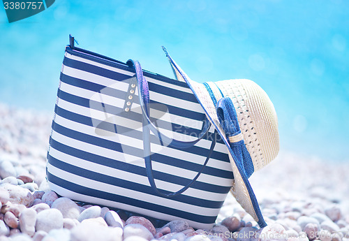 Image of bag and hat on the beach