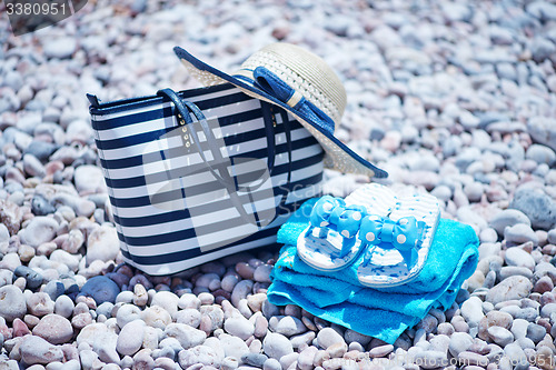 Image of bag and hat on the beach