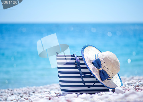 Image of bag and hat on the beach