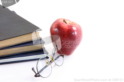 Image of red apple and books