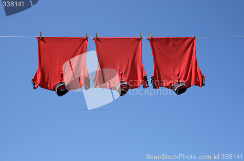 Image of Laundry, three red t-shirts