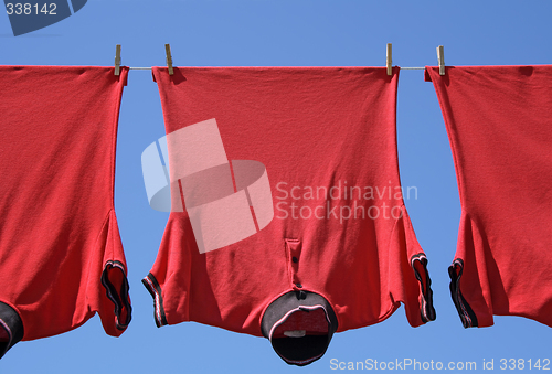 Image of Laundry closeup, three red t-shirts