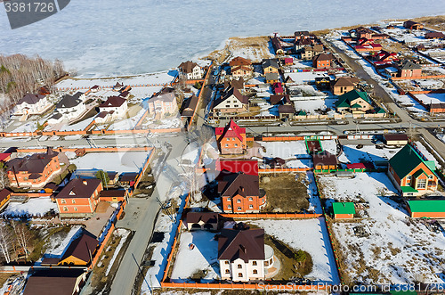 Image of Aerial view on suburban street near lake at spring