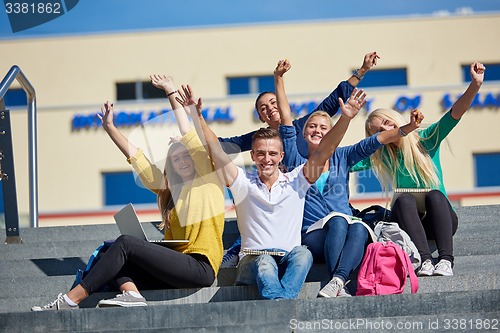 Image of students outside sitting on steps