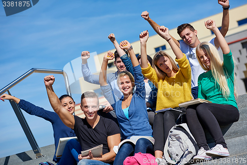 Image of students outside sitting on steps