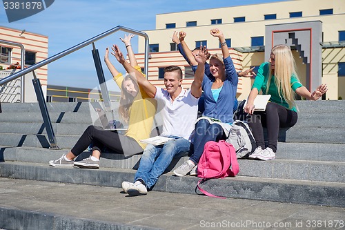 Image of students outside sitting on steps