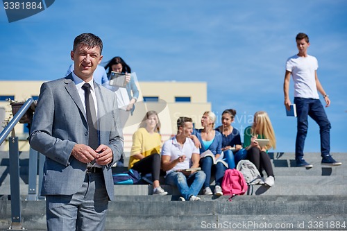 Image of students outside sitting on steps