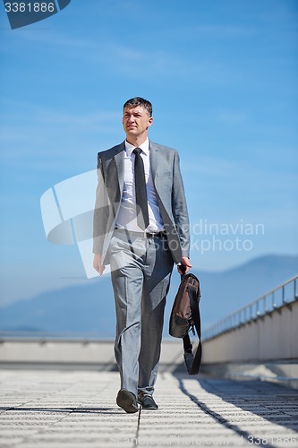 Image of senior  businessman outdoors