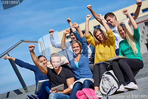 Image of students outside sitting on steps