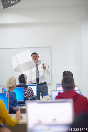 Image of students with teacher  in computer lab classrom