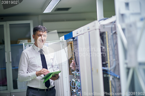 Image of network engineer working in  server room