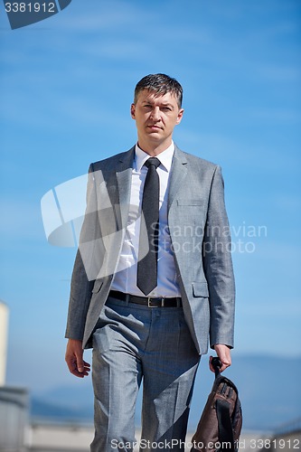 Image of senior  businessman outdoors