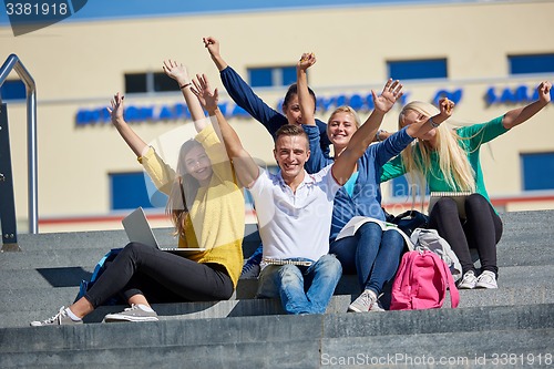 Image of students outside sitting on steps