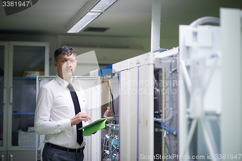 Image of network engineer working in  server room