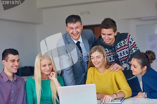 Image of group of students getting suppport from teacher