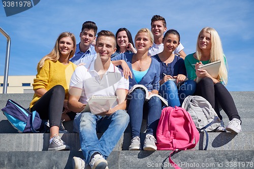 Image of students outside sitting on steps