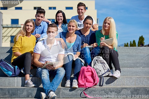 Image of students outside sitting on steps