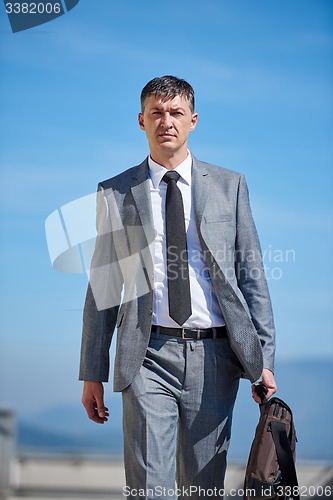 Image of senior  businessman outdoors