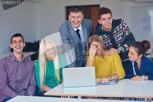 Image of group of students getting suppport from teacher