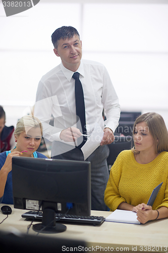 Image of students with teacher  in computer lab classrom