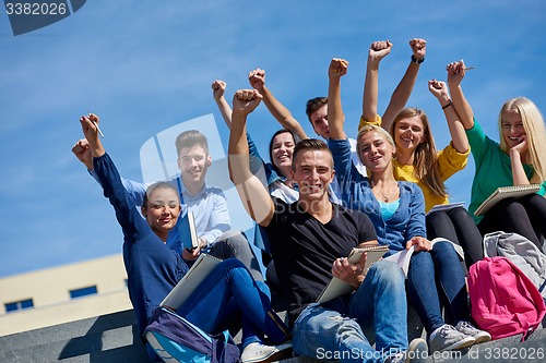 Image of students outside sitting on steps