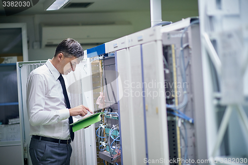 Image of network engineer working in  server room